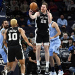 
              San Antonio Spurs center Jakob Poeltl (25) grabs the ball in the first half of an NBA basketball game against the Memphis Grizzlies, Monday, Jan. 9, 2023, in Memphis, Tenn. (AP Photo/Brandon Dill)
            