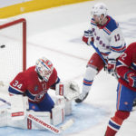 
              Montreal Canadiens goaltender Jake Allen is scored on by New York Rangers' Filip Chytil (not shown) as Rangers' Alexis Lafreniere (13) and Canadiens' Arber Xhekaj (72) look for a rebound during the second period of an NHL hockey game in Montreal on Thursday, Jan. 5, 2023. (Graham Hughes/The Canadian Press via AP)
            