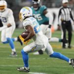 
              Los Angeles Chargers cornerback Asante Samuel Jr. (26) runs back an interception against the Jacksonville Jaguars during the first half of an NFL wild-card football game, Saturday, Jan. 14, 2023, in Jacksonville, Fla. (AP Photo/Chris O'Meara)
            