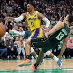 
              Boston Celtics' Malcolm Brogdon (13) commits a flagrant foul on Los Angeles Lakers' Russell Westbrook (0) during overtime in an NBA basketball game Saturday, Jan. 28, 2023, in Boston. (AP Photo/Michael Dwyer)
            