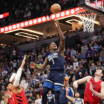 
              Minnesota Timberwolves guard Anthony Edwards (1) goes up for a shot past Portland Trail Blazers forward Josh Hart, left, and center Drew Eubanks, during the second half of an NBA basketball game, Wednesday, Jan. 4, 2023, in Minneapolis. Edwards had 32 points as the Timberwolves won 113-106. (AP Photo/Craig Lassig)
            