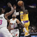 
              Los Angeles Lakers guard Kendrick Nunn, right, shoots as Miami Heat center Bam Adebayo, left, defends along with guard Gabe Vincent during the first half of an NBA basketball game Wednesday, Jan. 4, 2023, in Los Angeles. (AP Photo/Mark J. Terrill)
            