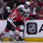 
              Los Angeles Kings center Anze Kopitar, right, is checked by Chicago Blackhawks defenseman Ian Mitchell during the first period of an NHL hockey game in Chicago, Sunday, Jan. 22, 2023. (AP Photo/Nam Y. Huh)
            