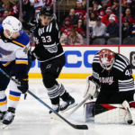 
              New Jersey Devils goaltender Akira Schmid (40) stops a shot by St. Louis Blues' Ivan Barbashev (49) during the second period of an NHL hockey game Thursday, Jan. 5, 2023, in Newark, N.J. (AP Photo/Frank Franklin II)
            