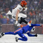 
              Cincinnati Bengals tight end Hayden Hurst (88) leaps over Buffalo Bills safety Jaquan Johnson (4) during the third quarter of an NFL division round football game, Sunday, Jan. 22, 2023, in Orchard Park, N.Y. (AP Photo/Joshua Bessex)
            