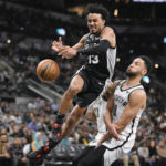
              San Antonio Spurs' Tre Jones (33) loses the ball as he collides with Brooklyn Nets' Ben Simmons during the second half of an NBA basketball game Tuesday, Jan. 17, 2023, in San Antonio. (AP Photo/Darren Abate)
            