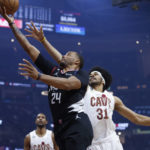 
              Los Angeles Clippers forward Norman Powell (24) shoots against Cleveland Cavaliers center Jarrett Allen (31) during the first half of an NBA basketball game, Sunday, Jan. 29, 2023, in Cleveland. (AP Photo/Ron Schwane)
            