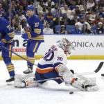 
              New York Islanders goaltender Ilya Sorokin (30) blocks a shot by Buffalo Sabres center Casey Mittelstadt (37) as left wing Victor Olofsson (71) watches during the first period of an NHL hockey game Thursday, Jan. 19, 2023, in Buffalo, N.Y. (AP Photo/Joshua Bessex)
            