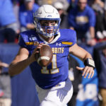
              South Dakota State quarterback Mark Gronowski (11) looks to pass during the first half of the FCS Championship NCAA college football game against the North Dakota, Sunday, Jan. 8, 2023, in Frisco, Texas. (AP Photo/LM Otero)
            