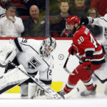 
              Los Angeles Kings goaltender Pheonix Copley (29) freezes the puck in front of Carolina Hurricanes' Jordan Martinook (48) and Kings' Mikey Anderson (44) during the first period of an NHL hockey game in Raleigh, N.C., Tuesday, Jan. 31, 2023. (AP Photo/Karl B DeBlaker)
            