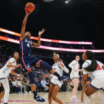 
              Connecticut's Aubrey Griffin (44) shoots over St. John's Sitota Gines (11) and Skye Owen (12) during the second half of an NCAA basetball game Wednesday, Jan. 11, 2023, in New York. Connecticut won 82-52. (AP Photo/Frank Franklin II)
            