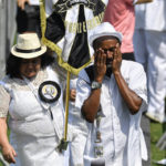 
              A fan of Pele wipes tears in a line of people waiting to pay their last respects to the late Brazilian soccer great, lying in state at Vila Belmiro stadium, in Santos, Brazil, Monday, Jan. 2, 2023. (AP Photo/Matias Delacroix)
            