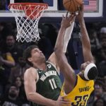 
              Indiana Pacers' Myles Turner (33) has his shot blocked by Milwaukee Bucks' Brook Lopez (11) during the second half of an NBA basketball game, Friday, Jan. 27, 2023, in Indianapolis. (AP Photo/Darron Cummings)
            
