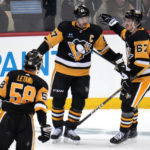 
              Pittsburgh Penguins' Sidney Crosby celebrates his goal with Rickard Rakell (67) during the first period of an NHL hockey game against the San Jose Sharks in Pittsburgh, Saturday, Jan. 28, 2023. (AP Photo/Gene J. Puskar)
            