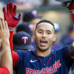 
              FILE - Minnesota Twins' Carlos Correa is congratulated after hitting a solo home run against the Los Angeles Angels during the first inning of a baseball game in Anaheim, Calif., Saturday, Aug. 13, 2022. Carlos Correa reversed course for a second time, agreeing Tuesday to a $200 million, six-year contract that keeps him with the Minnesota Twins after failing to complete agreements with the New York Mets and San Francisco Giants, a person familiar with the negotiations told The Associated Press on Tuesday, Jan. 10, 2022. (AP Photo/Alex Gallardo, File)
            