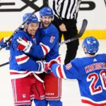 
              New York Rangers' K'Andre Miller (79) celebrates with Ben Harpur (5) and Chris Kreider (20) after scoring a goal during the third period of an NHL hockey game against the Carolina Hurricanes Tuesday, Jan. 3, 2023, in New York. The Rangers won 5-3. (AP Photo/Frank Franklin II)
            