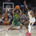 
              Baylor guard LJ Cryer (4) is defended by Texas guard Marcus Carr (5) during the first half of an NCAA college basketball game Monday, Jan. 30, 2023, in Austin, Texas. (AP Photo/Stephen Spillman)
            