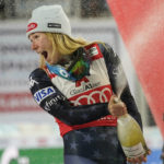 
              United States' Mikaela Shiffrin celebrates on podium after finishing second in a alpine ski, women's World Cup slalom in Flachau, Austria, Tuesday, Jan.10, 2023. American skier Mikaela Shiffrin finished second to Olympic champion Petra Vlhova in a night slalom race Tuesday, meaning she will have to wait for another chance to break the record for most wins on the women’s World Cup circuit. (AP Photo/Giovanni Auletta)
            