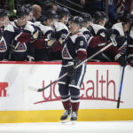 
              Colorado Avalanche center Evan Rodrigues, front, is congratulated after scoring a goal as he skates by the team bench in the second period of an NHL hockey game against the St. Louis Blues, Saturday, Jan. 28, 2023, in Denver. (AP Photo/David Zalubowski)
            
