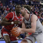
              Gonzaga forward Drew Timme, right, drives while defended by Loyola Marymount center Rick Issanza during the second half of an NCAA college basketball game, Thursday, Jan. 19, 2023, in Spokane, Wash. Loyola Marymount won 68-67. (AP Photo/Young Kwak)
            