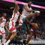 
              Detroit Pistons center Jalen Duren grabs a rebound next to Houston Rockets forward Jabari Smith Jr., center left and forward Bruno Fernando (20) during the first half of an NBA basketball game, Saturday, Jan. 28, 2023, in Detroit. (AP Photo/Carlos Osorio)
            