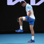 
              Novak Djokovic of Serbia stretches his leg during his second round match against Enzo Couacaud of France at the Australian Open tennis championship in Melbourne, Australia, Thursday, Jan. 19, 2023. (AP Photo/Dita Alangkara)
            