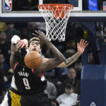 
              Indiana Pacers guard Chris Duarte, top, blocks a shot by Portland Trail Blazers forward Jerami Grant (9) during the second quarter of an NBA basketball game, Friday, Jan. 6, 2023, in Indianapolis. (AP Photo/Marc Lebryk)
            