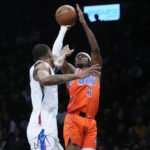 
              Oklahoma City Thunder's Shai Gilgeous-Alexander (2) shoots over Brooklyn Nets' Nic Claxton during the second half of an NBA basketball game Sunday, Jan. 15, 2023 in New York. (AP Photo/Frank Franklin II)
            