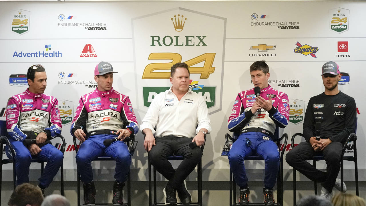 The Meyer Shank Racing team, from left, Helio Castroneves, Simon Pagenaud, Michael Shank, Colin Bra...