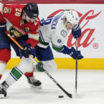 
              Florida Panthers defenseman Josh Mahura (28) and Vancouver Canucks center Jack Studnicka (18) battle for the puck during the second period of an NHL hockey game, Saturday, Jan. 14, 2023, in Sunrise, Fla. (AP Photo/Wilfredo Lee)
            