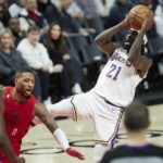 
              Los Angeles Lakers guard Patrick Beverley, right, shoots while being fouled by Portland Trail Blazers guard Damian Lillard during the second half of an NBA basketball game in Portland, Ore., Sunday, Jan. 22, 2023. (AP Photo/Craig Mitchelldyer)
            