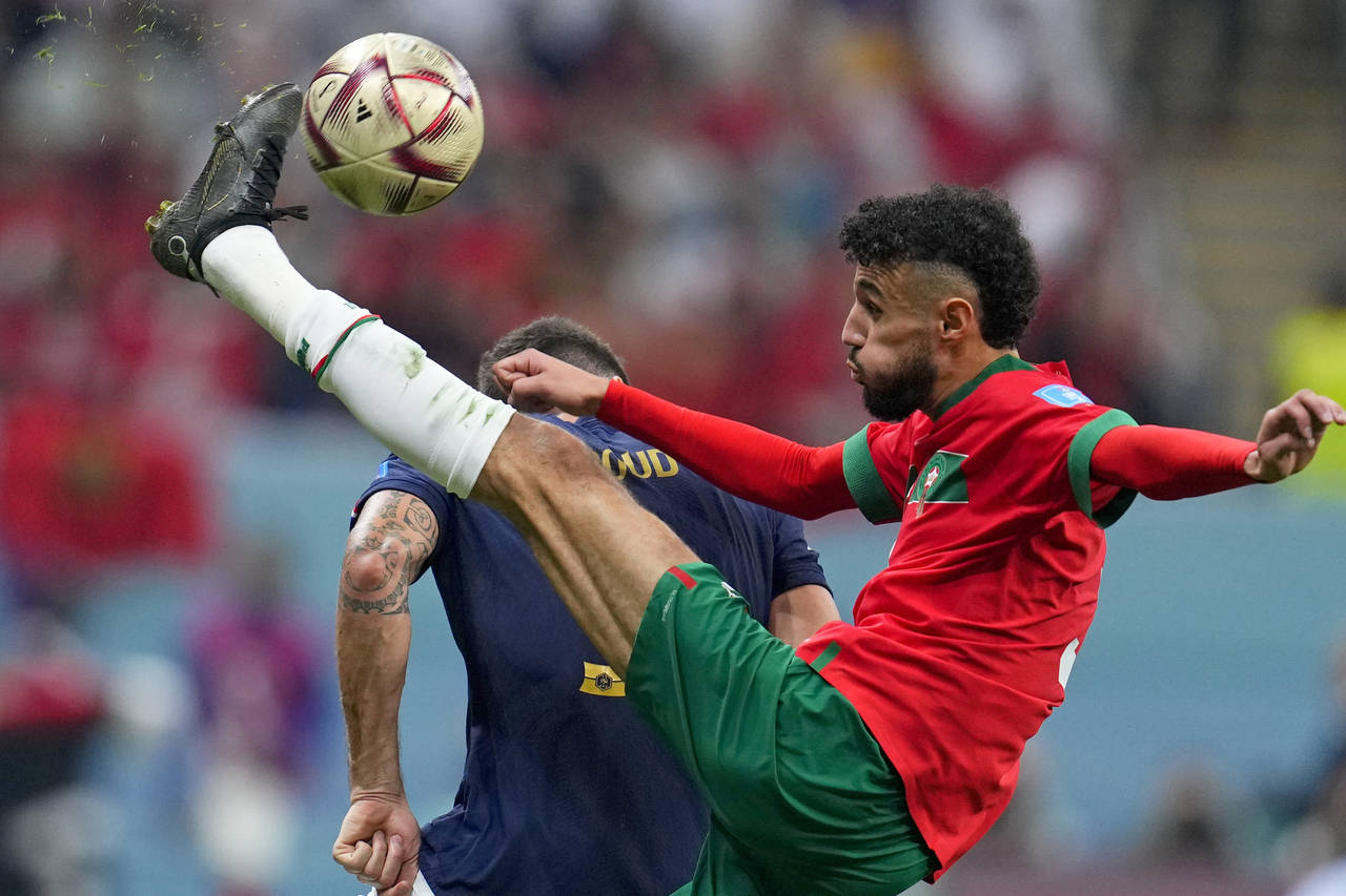 Morocco's Noussair Mazraoui connects a shot during the World Cup semifinal soccer match between Fra...