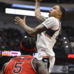 
              UConn's Jordan Hawkins shoots over St. John's Dylan Addae-Wusu (5) in the second half of an NCAA college basketball game, Sunday, Jan. 15, 2023, in Hartford, Conn. (AP Photo/Jessica Hill)
            