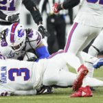 
              CLARIFIES THAT IMAGE SHOWN IS FROM THE END OF A TACKLE SECONDS BEFORE HAMLIN COLLAPSED - Buffalo Bills safety Damar Hamlin (3) lies on the turf after making a tackle on Cincinnati Bengals wide receiver Tee Higgins, who is blocked from view, as Buffalo Bills linebacker Tremaine Edmunds (49) assists at the end of the play during the first half of an NFL football game between the Cincinnati Bengals and the Buffalo Bills, Monday, Jan. 2, 2023, in Cincinnati. After getting up from the play, Hamlin collapsed and was administered CPR on the field. (AP Photo/Joshua A. Bickel)
            