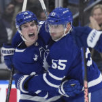 
              Toronto Maple Leafs right wing Mitchell Marner (16) celebrates his short-handed goal with teammate Toronto Maple Leafs defenseman Mark Giordano (55) during the second period of an NHL hockey game, Thursday, Jan. 19, 2023 in Toronto. (Nathan Denette/The Canadian Press via AP)
            