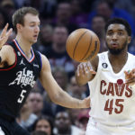 
              Cleveland Cavaliers guard Donovan Mitchell (45) passes against Los Angeles Clippers guard Luke Kennard (5) during the first half of an NBA basketball game, Sunday, Jan. 29, 2023, in Cleveland. (AP Photo/Ron Schwane)
            