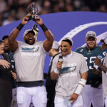 
              Terry Bradshaw, left, reacts as Philadelphia Eagles defensive tackle Fletcher Cox, second from left, hoists the George Halas Trophy as quarterback Jalen Hurts, center, holds a microphone after the NFC Championship NFL football game between the Philadelphia Eagles and the San Francisco 49ers on Sunday, Jan. 29, 2023, in Philadelphia. The Eagles won 31-7. (AP Photo/Seth Wenig)
            