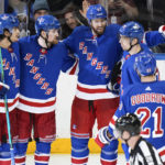 
              New York Rangers' Ben Harpur, center, celebrates with teammates after scoring a goal during the third period of an NHL hockey game against the Boston Bruins Thursday, Jan. 19, 2023, in New York. The Bruins won 3-1. (AP Photo/Frank Franklin II)
            