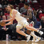 
              Utah Jazz's Kelly Olynyk, left, is fouled by Houston Rockets' Kevin Porter Jr. (3) during the first half of an NBA basketball game Thursday, Jan. 5, 2023, in Houston. (AP Photo/David J. Phillip)
            