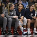 
              UConn's Paige Bueckers, second from left, talks with teammate Azzi Fudd in the second half of an NCAA college basketball game, Sunday, Jan. 15, 2023, in Hartford, Conn. Fudd left the game in the first half with an injury to her knee and did not return. (AP Photo/Jessica Hill)
            