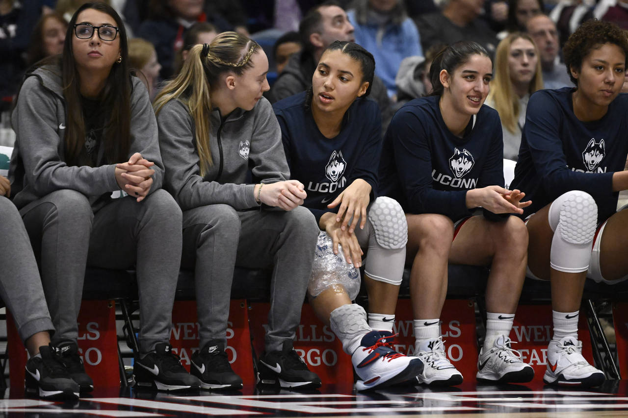 UConn's Paige Bueckers, second from left, talks with teammate Azzi Fudd in the second half of an NC...