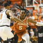 
              Texas guard Marcus Carr (5) tangles up with Oklahoma State guard Avery Anderson III (0) during the second half of an NCAA college basketball game Saturday, Jan. 7, 2023, in Stillwater, Okla. Texas defeated Oklahoma State 56-46. (AP Photo/Brody Schmidt)
            