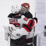 
              New Jersey Devils' Jack Hughes and Vitek Vanecek (41) celebrate after Hughes scored in overtime of an NHL hockey game against the Dallas Stars, Friday, Jan. 27, 2023, in Dallas. The Devils won 3-2. (AP Photo/Tony Gutierrez)
            