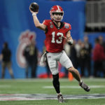 
              Georgia quarterback Stetson Bennett (13) passes the ball against Ohio State during the first half of the Peach Bowl NCAA college football semifinal playoff game, Saturday, Dec. 31, 2022, in Atlanta. (AP Photo/John Bazemore)
            
