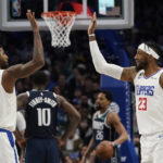 
              Los Angeles Clippers forward Robert Covington (23) and guard Paul George (13) celebrate a play during the second half of an NBA basketball game in Dallas, Sunday, Jan. 22, 2023. The Clippers won 112-98. (AP Photo/LM Otero)
            