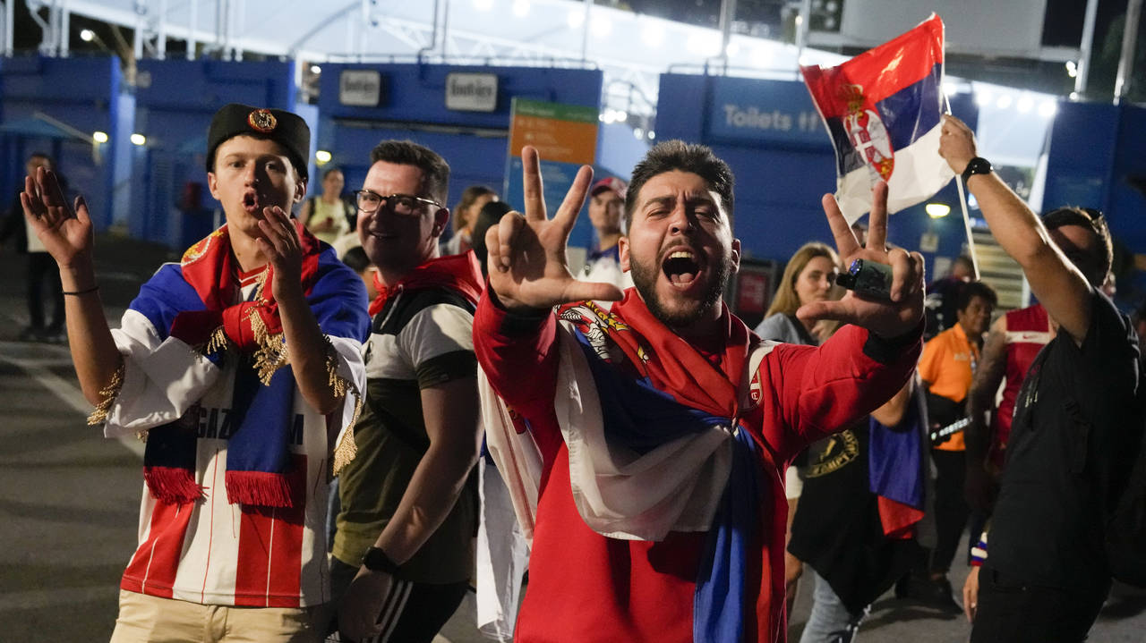 Supporters of Novak Djokovic of Serbia celebrate outside Rod Laver Arena after he defeated Tommy Pa...