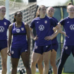 
              U.S. national team player Crystal Dunn, second from left, listens to instructions with teammates during practice for a match against Nigeria Tuesday, Aug. 30, 2022, in Riverside, Mo. Women’s soccer in the United States has struggled with diversity, starting with a pay-to-play model that can exclude talented kids from communities of color. (AP Photo/Charlie Riedel)
            