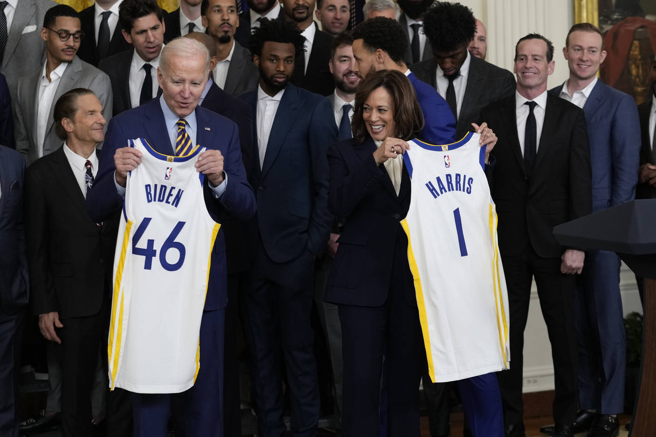 President Joe Biden and Vice President Kamala Harris hold up team jerseys as they welcome the 2022 ...