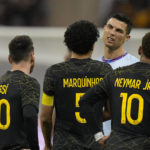 
              Cristiano Ronaldo grimaces playing for a combined XI of Saudi Arabian teams Al Nassr and Al Hilal is flanked by PSG's Lionel Messi and his teammates Neymar and Marquinhos during a friendly soccer match, at the King Saud University Stadium, in Riyadh, Saudi Arabia, Thursday, Jan. 19, 2023. (AP Photo/Hussein Malla)
            