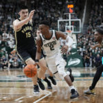 
              Michigan State guard Tyson Walker (2) drives as Purdue center Zach Edey (15) defends during the second half of an NCAA college basketball game, Monday, Jan. 16, 2023, in East Lansing, Mich. (AP Photo/Carlos Osorio)
            